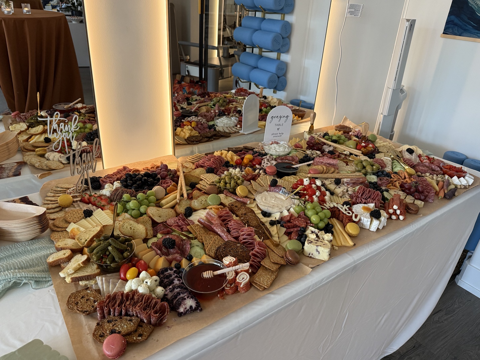 Gather & Graze table filled with artisan cheeses, salami, fresh fruit, crackers, and dips